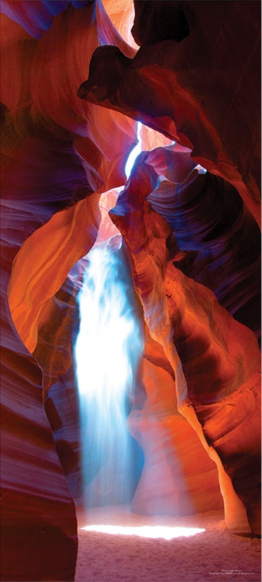 Ghostlike shaft of light and falling sand between sculpted sandstone walls in Ghost Canyon